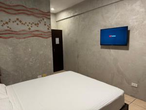 a bedroom with a bed and a flat screen tv at Casa P in Candelaria