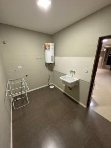 a bathroom with a sink and a water heater at Apart hotel JJ - a estrenar in Paso de los Libres