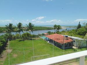 an aerial view of a house with a soccer field at CASA NA BARRA DE SANTO ANTONIO in Barra de Santo Antônio