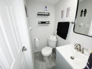 迈阿密Unique Miami Art Escape w/ HotTub, Arcade & Murals的白色的浴室设有卫生间和水槽。 更多15张照片