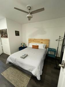 a bedroom with a bed and a ceiling fan at Charming Philly Row 2 Units in Philadelphia