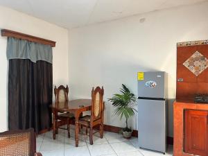 a kitchen with a table and a refrigerator at Apartamento Los Monges in León