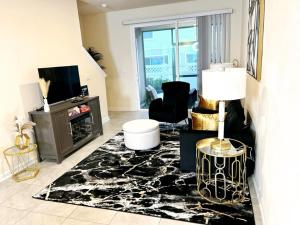a living room with a black and white rug at Orange Park Townhome Vacation Rental with Patio! in Orange Park