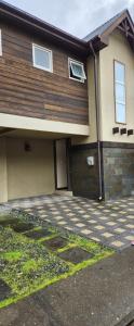 a house with a driveway in front of it at Casa Pucon Wi Fi Disponible in Pucón