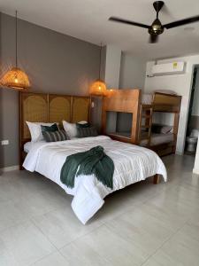 a bedroom with a large bed and a table at DELAMAR Casa de playa in Coveñas