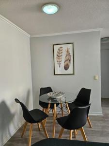 a dining room with a table and chairs at Condominio Florencia 524 in La Serena