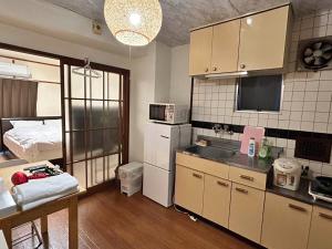 a kitchen with a sink and a bed in a room at Nishimoto Building - Vacation STAY 16004v in Hiroshima