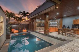 a swimming pool in the middle of a house at 2 Bed Beachfront Villa Echo Beach in Canggu