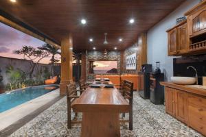 a kitchen with a table and a swimming pool at 2 Bed Beachfront Villa Echo Beach in Canggu