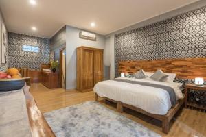 a bedroom with a large bed in a room at 2 Bed Beachfront Villa Echo Beach in Canggu