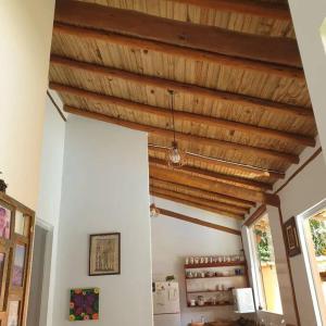 a room with a wooden ceiling in a house at Tiny house in Porto Seguro