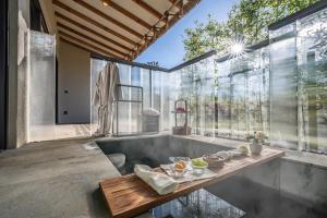 濟州的住宿－琥珀璞山度假村济州，带浴缸的浴室和大窗户