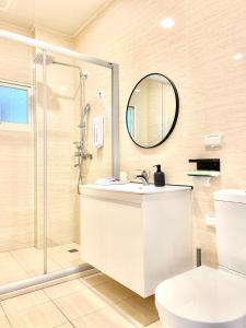 沙沙民宿 في ماغونغ: حمام مع مرحاض ومغسلة ودش