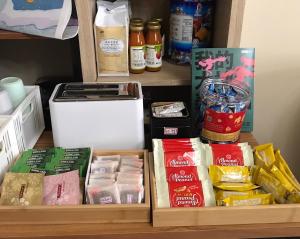 a shelf with various food items in a pantry at Books & Woods Bed and Breakfast in Taitung City