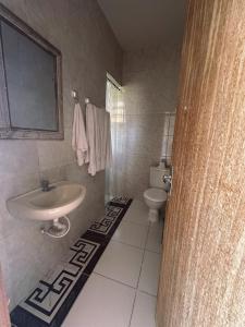 a bathroom with a sink and a toilet at Casa alto Vidigal in Rio de Janeiro