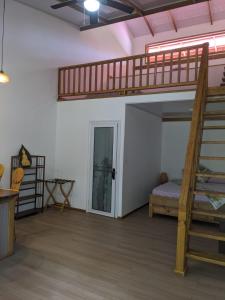 a bedroom with a bunk bed and a staircase at Playa Bluff Lodge in Bocas Town