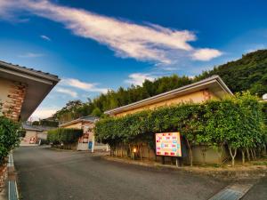 a building with ivy on the side of a street at SKY Ocean-terace Omura in Omura