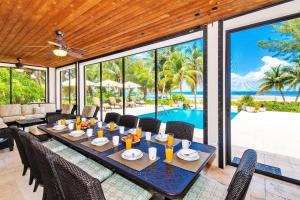 a dining room with a table and chairs and a pool at Moon Kai home in Driftwood Village