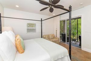 a bedroom with a bed and a ceiling fan at Moon Kai home in Driftwood Village