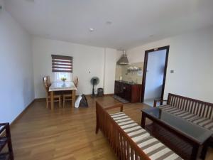 a living room with a table and a dining room at Kingdom Danang Hotel in Da Nang