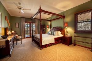 a bedroom with a canopy bed and a desk at Maya Sanctuary in Little Hartley