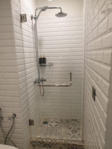 a bathroom with a shower with a tiled floor at Omah Kumpul Sentul in Bogor
