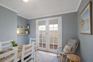 a room with a bed and chairs and a window at Southport in Port Fairy