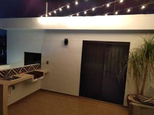 a room with a sink and a door with a plant at Depa independiente con Terraza Super ubicado . in Ciudad Madero