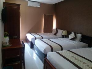 Ένα ή περισσότερα κρεβάτια σε δωμάτιο στο Kingdom Danang Hotel