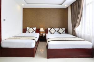 Ένα ή περισσότερα κρεβάτια σε δωμάτιο στο Kingdom Danang Hotel