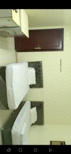 a bathroom with a toilet and rolls of toilet paper at عمارة سكنية مخدومة قريبه من الحرم in Al Khansāk