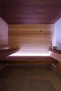 a sauna with a bench in a room at Bella Hotel & Restaurant with private dock for mooring boats in San Felice del Benaco