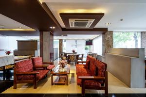 a lobby with couches and a table and chairs at La Palma Boutique Hotel in Ho Chi Minh City