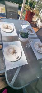 a glass table with plates of food on it at Views of the Tamar River in Clarence Point