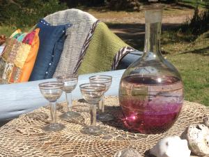 a group of wine glasses and a bottle on a table at BARAKA - Posada in Piriápolis