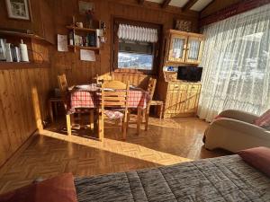 a kitchen with a table and chairs in a room at Charmant appartement T2 à Praz sur Arly avec parking et balcon - 300m du village, 600m des pistes - FR-1-603-88 in Praz-sur-Arly