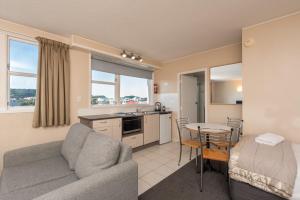 a living room with a couch and a table at Capital View Motor Inn in Wellington