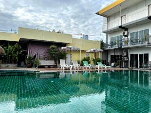 a swimming pool in front of a building at Anantra Pattaya Resort in Pattaya Central