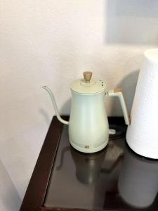 a white blender sitting on a shelf next to a roll of paper towels at Guest House next to Little Italy in San Diego