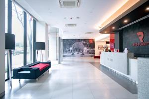 a lobby with a couch in the middle of a building at Red Planet BGC The Fort in Manila