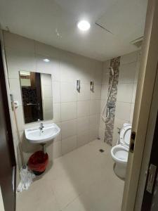 a bathroom with a sink and a toilet at Orchard Apartment Pakuwon Mansion 2 by Shinzhouz in Surabaya