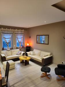 a living room with two couches and a table at Ahr-Weinbergblick in Bad Neuenahr-Ahrweiler