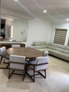 a dining room with a table and chairs and a couch at Casa Portobello in La Paz