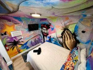 a bedroom with a dinosaur painted on the wall at Cozy & Colorful Miami Art Canvas w/HotTub & Murals in Miami