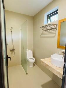 a bathroom with a shower and a toilet and a sink at ARECA MUINE HOMESTAY in Phan Thiet