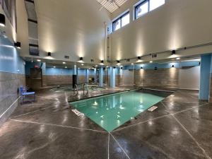a pool in the middle of a room at Solara Escape - 2BR Retreat with Pool - Hot Tub - Gym - Spa in Canmore