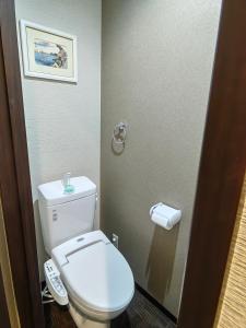 a bathroom with a toilet and a remote control at Mini Inn Kyoto 京都 - 外国人向け - 日本人予約不可 in Kyoto