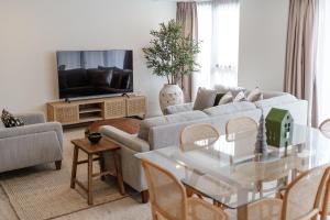 a living room with a couch and a table at Breeze Mooloolaba, Ascend Hotel Collection in Mooloolaba