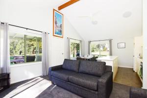 a living room with a couch and a table at Beau Villa - Two bedroom Villa on golf course in Kangaroo Valley