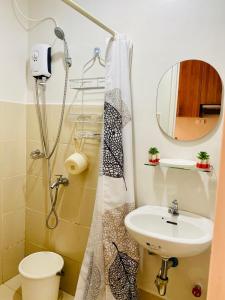 a bathroom with a sink and a toilet and a shower at Prime Studio at The Loop Tower in Cagayan de Oro